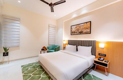 a bedroom with a large white bed in a room at Scarlet in Indore