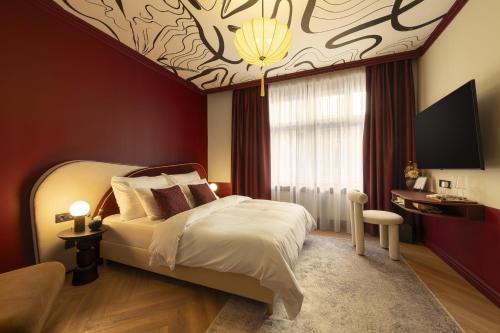 a bedroom with a bed and a ceiling with a painting at TWENTYSEVEN Boutique in Budapest