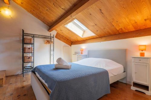 a bedroom with a bed in a room with wooden ceilings at Élégant T3 Terrasse & Wifi in Vals-les-Bains
