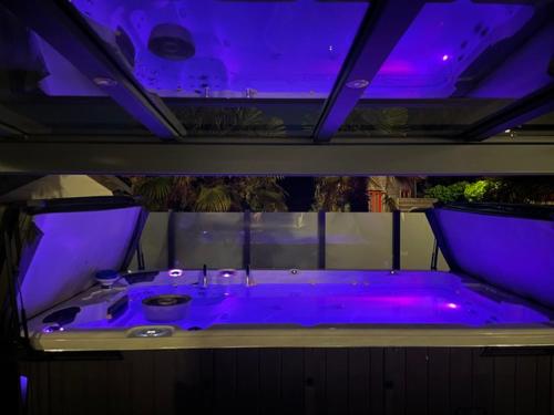 a purple bathroom with a tub with a sink at Chalet Roma 200 in Sint Annaland