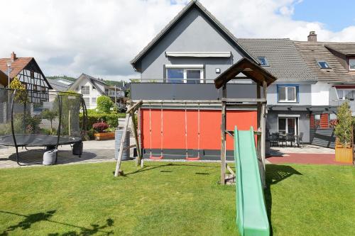 a playground in a yard with a swing set at Ferienhaus Sieger in Salem