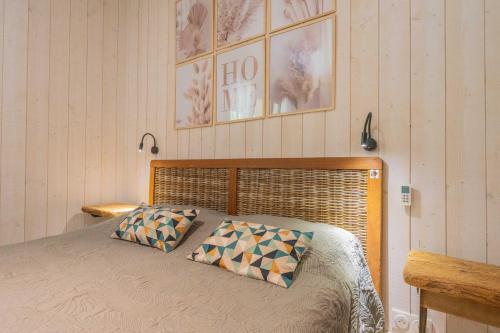 a bedroom with a bed with two pillows on it at Gite - La grange Tima in Orgeix