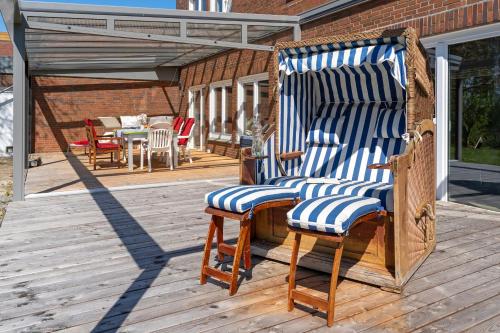 a porch with a rocking chair on a deck at Ostseeschwimmerin in Schönberg