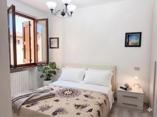 a bedroom with a bed and a window at Piccola Corte in Fano