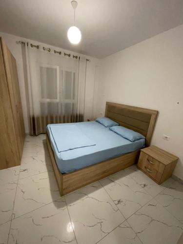 a bedroom with a bed in a room with a window at Hotel Infinity Shëngjin in Lezhë