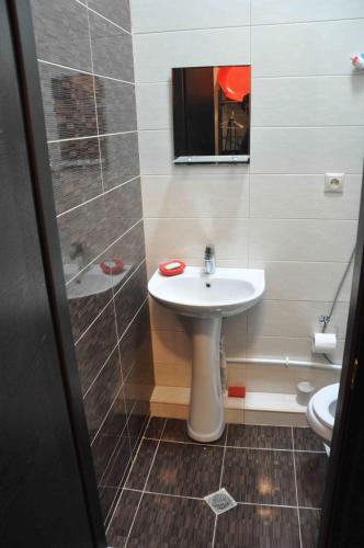 a bathroom with a white sink and a mirror at Ski Sun & Fun - next to iconic Marco Polo in Gudauri
