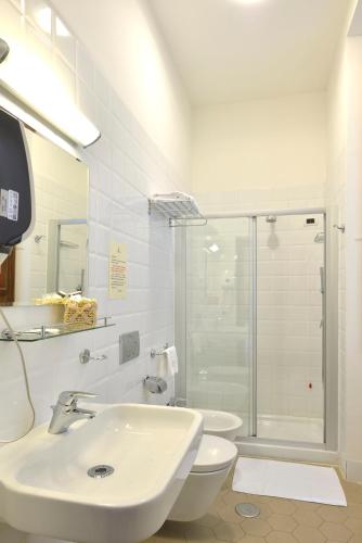 a bathroom with a sink and a toilet and a shower at Casa I Cappuccini in Rome