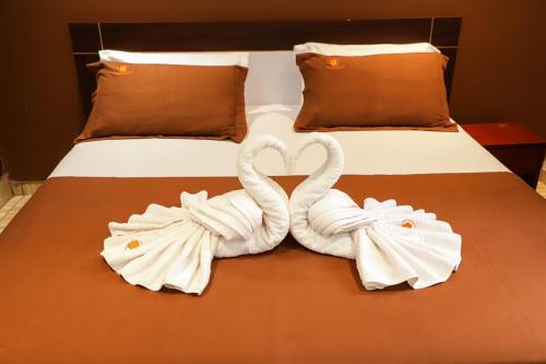 two swans towels are sitting on a bed at Résidences AMAN in Morofé