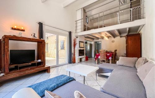 a living room with two couches and a tv at Maison Proche Uzès in Vers Pont du Gard