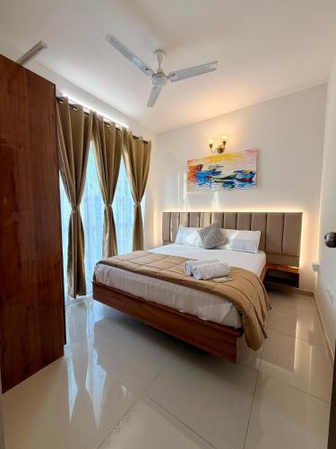 a bedroom with a large bed in a room at Bay Breeze 2BR Apt Amoret Homes in Chicalim