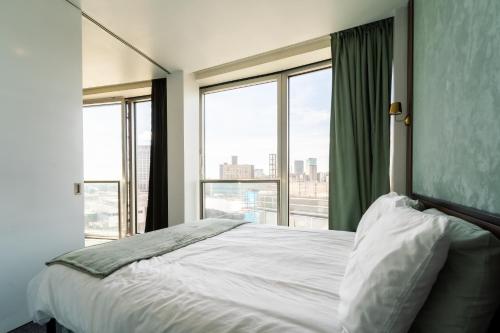 a bedroom with a bed and a large window at THE OLIVE SUITE At The Rotunda in Birmingham