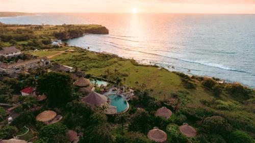 an aerial view of a resort with a pool and the ocean at La Joya Balangan Resort in Jimbaran