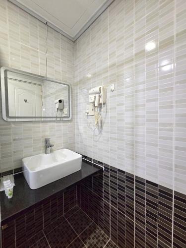 a bathroom with a sink and a mirror at Gold Ocean Apartment Nha Trang in Nha Trang