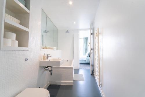 a white bathroom with a sink and a toilet at THE OLIVE SUITE At The Rotunda in Birmingham