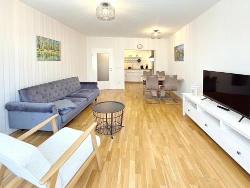 a living room with a couch and a tv at Altstadtidyll in Lübbenau
