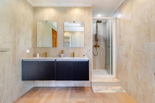 a bathroom with a sink and a mirror and a shower at Villa Zina in Pasiano di Pordenone