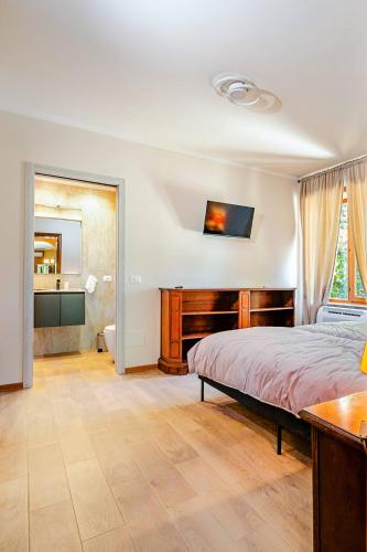 a bedroom with a bed and a desk and a sink at Villa Zina in Pasiano di Pordenone