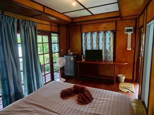 a bedroom with a bed with a bow on it at Koh kood Neverland beach resort in Ko Kood