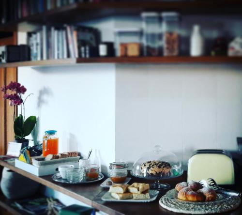 a table with plates of pastries and bread on it at Bed & Breakfast Ca' di Camineve in Loano