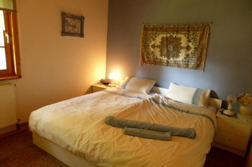 a bedroom with a bed with two towels on it at Anglo-Polish Holidays in Chycina