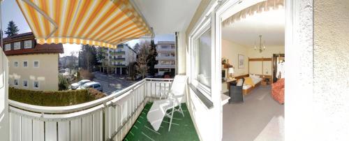 a balcony with a white railing and a view of a street at Kneipp-Kurhotel Steinle in Bad Wörishofen