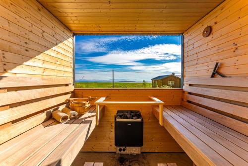 a sauna with a window in a wooden cabin at Villa Walter Lofoten with SAUNA in Kvalnes
