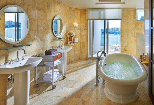 a bathroom with two sinks and a bath tub at Mandarin Oriental Miami in Miami