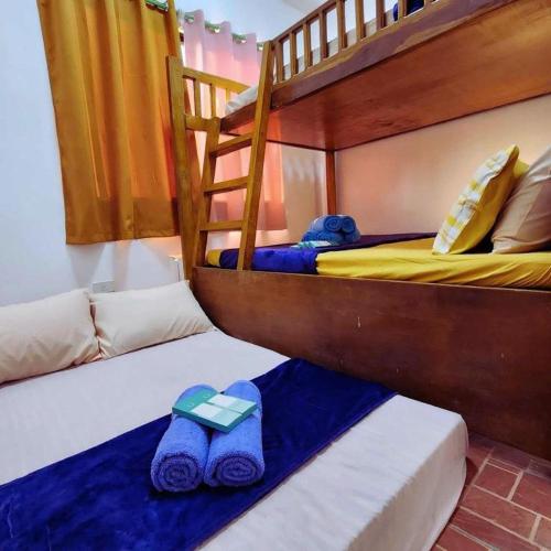 a bedroom with two bunk beds and a ladder at Pertible Beach Resort in Tondol