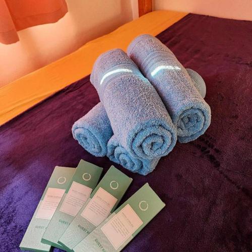 a group of rolled up towels on a bed at Pertible Beach Resort in Tondol