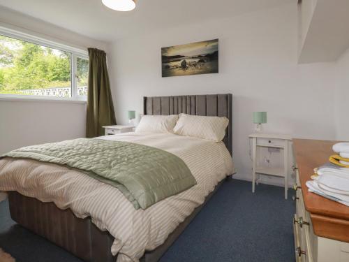 a bedroom with a bed and a desk and a window at 7 Chycoose Parc in Truro