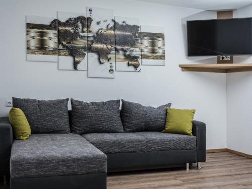 a living room with a couch and a tv at Alpenapart Frank in Längenfeld