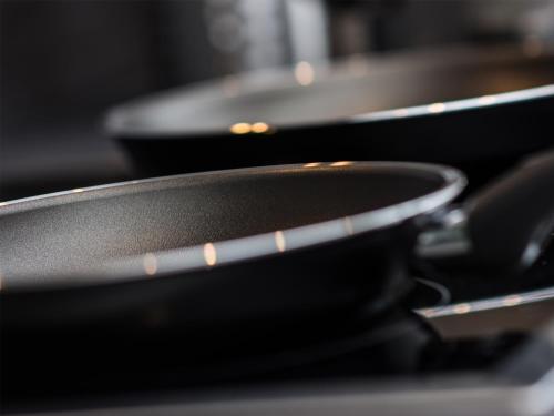 two pans sitting on top of a stove at Alpenapart Frank in Längenfeld
