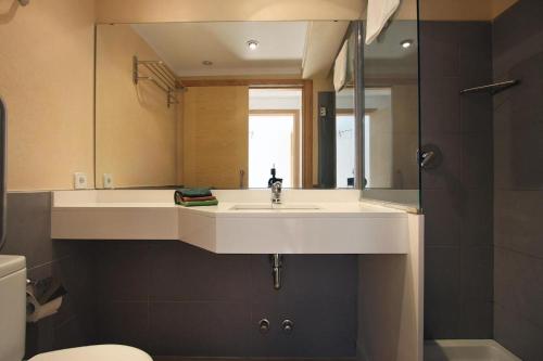a bathroom with a white sink and a mirror at Can Medina in Pollença