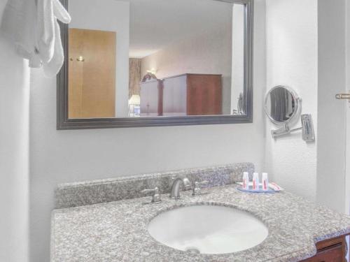 a bathroom counter with a sink and a mirror at Days Inn by Wyndham Eureka CA in Eureka