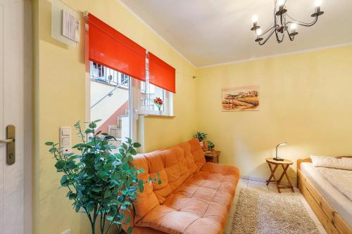 a living room with a couch and a window at Villa am Keltenberg - El Sol in Glauburg