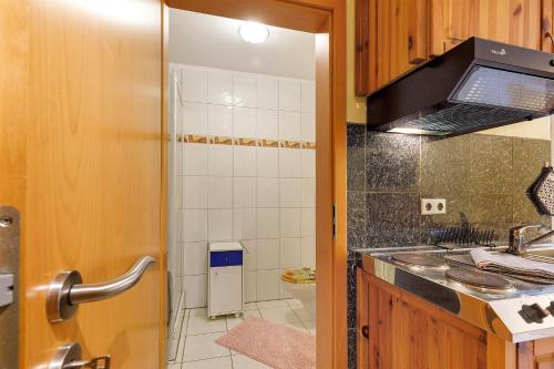 a small kitchen with a sink and a stove at Villa am Keltenberg - El Sol in Glauburg