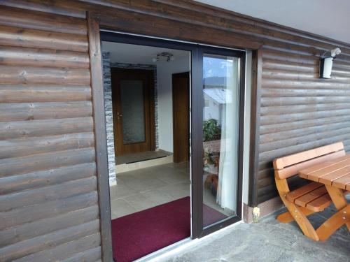 a sliding glass door of a house with a table at Frans Josef Apartments in Seeboden