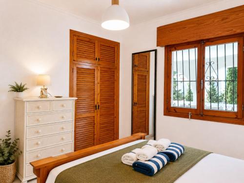 a bedroom with a bed with towels on it at Private Pool Villa La Siesta in La Mata