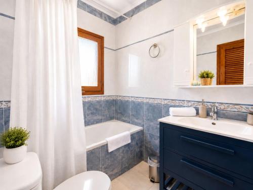 a bathroom with a toilet and a sink and a tub at Private Pool Villa La Siesta in La Mata