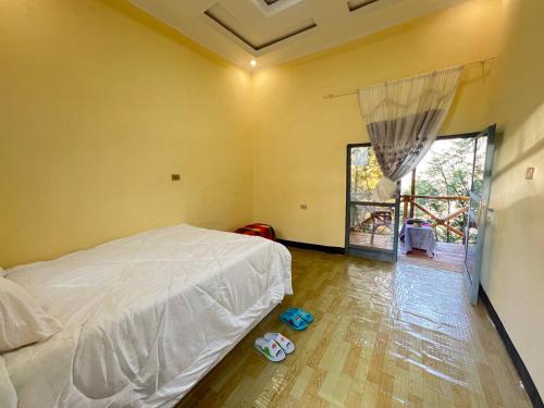 a bedroom with a white bed and a window at Addis View Homestay in Lalibela
