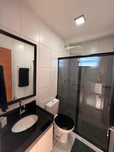 a bathroom with a toilet and a sink and a shower at Loft Luiz Gonzaga in Campina Grande
