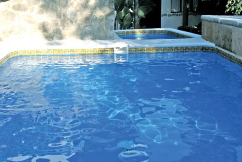 a swimming pool with blue water in it at La Casona Breakfast & Wellness Center in Temascaltepec de González
