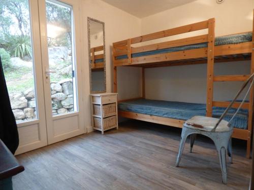 a bedroom with two bunk beds and a window at Casa Di Cavalone in Sainte-Lucie de Porto-Vecchio