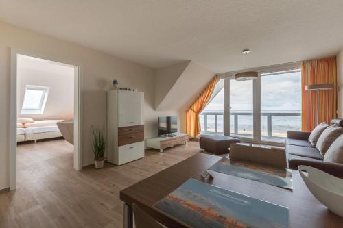 a living room with a couch and a table at Strandhaus Christiansen in Cuxhaven