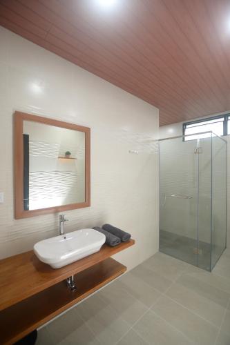 a bathroom with a sink and a glass shower at Villa Favore in Puncak