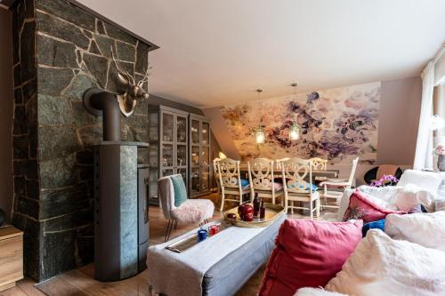 a living room with a fireplace and a stone wall at Ferienwohnungen Lemma in Möhnesee