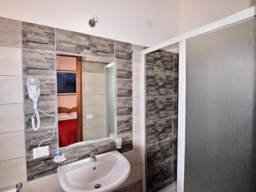 a bathroom with a sink and a mirror at Hotel Belvedere Lampedusa in Lampedusa