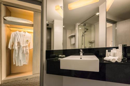 a bathroom with a white sink and a mirror at Sunway Hotel Georgetown Penang in George Town