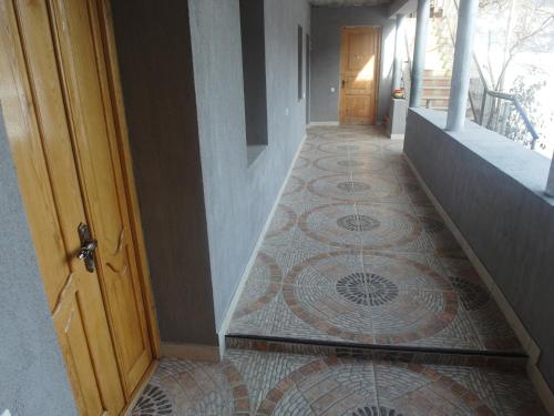 a hallway with a tiled floor with a door at Mestia 4 season in Mestia