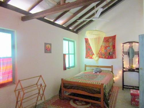 a bedroom with a bed and a ceiling at Mahagedara "Dream Villa" in Galle